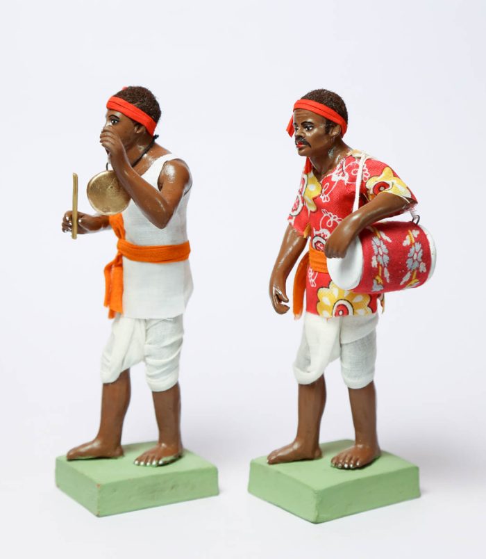 Dholok-aur-Ghanti-Bajanewala-Decorative-Showpiece-in-Clay-WhiteBG-SideView-RainbowFeathers.jpg Dholok-aur-Ghanti-Bajanewala-Decorative-Showpiece-in-Clay-WhiteBG-SideView-RainbowFeathers.jpg