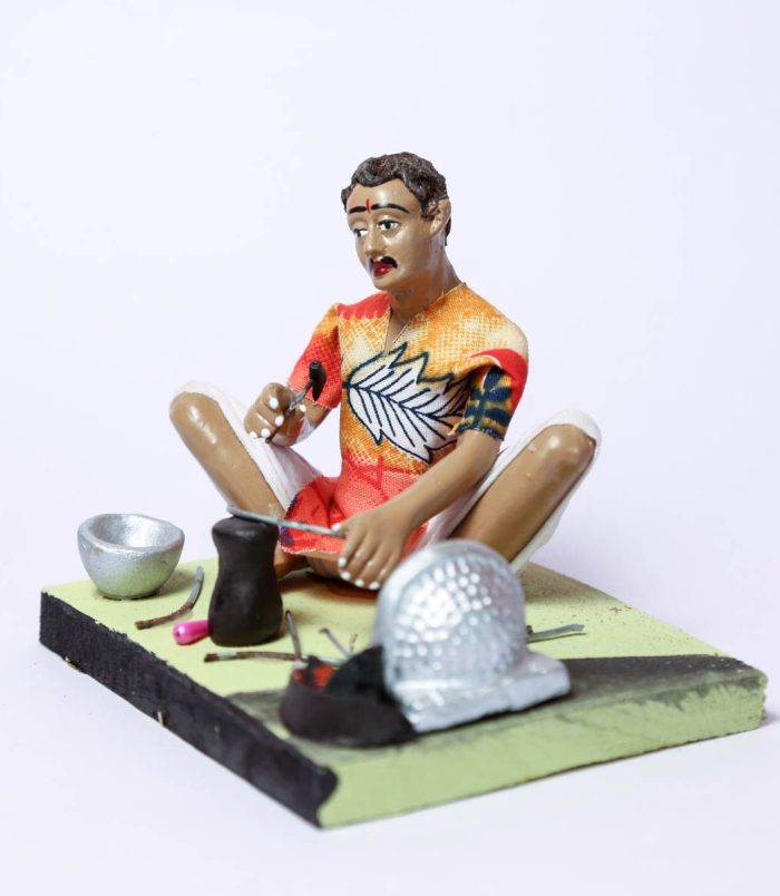 The-Indian-Blacksmith-Handmade-Decorative-Miniature-Clay-Figurine-SideView-RainbowFeathers.jpg